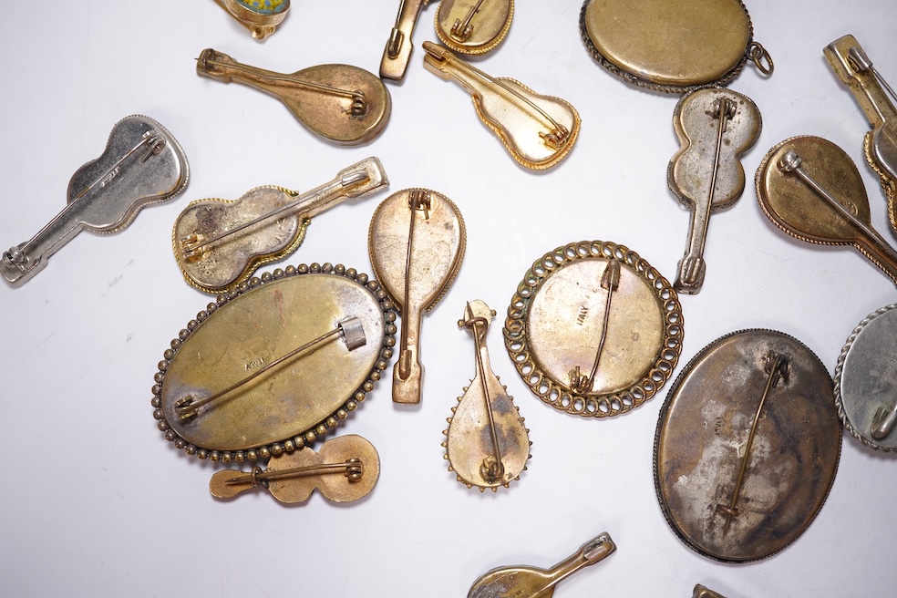 Thirty-one costume micro-mosaic brooches, to include seventeen guitar and banjo shaped brooches, five large oval/ circular brooches including scenic swan brooch, eight, smaller brooches and a pendant. Condition - fair/go